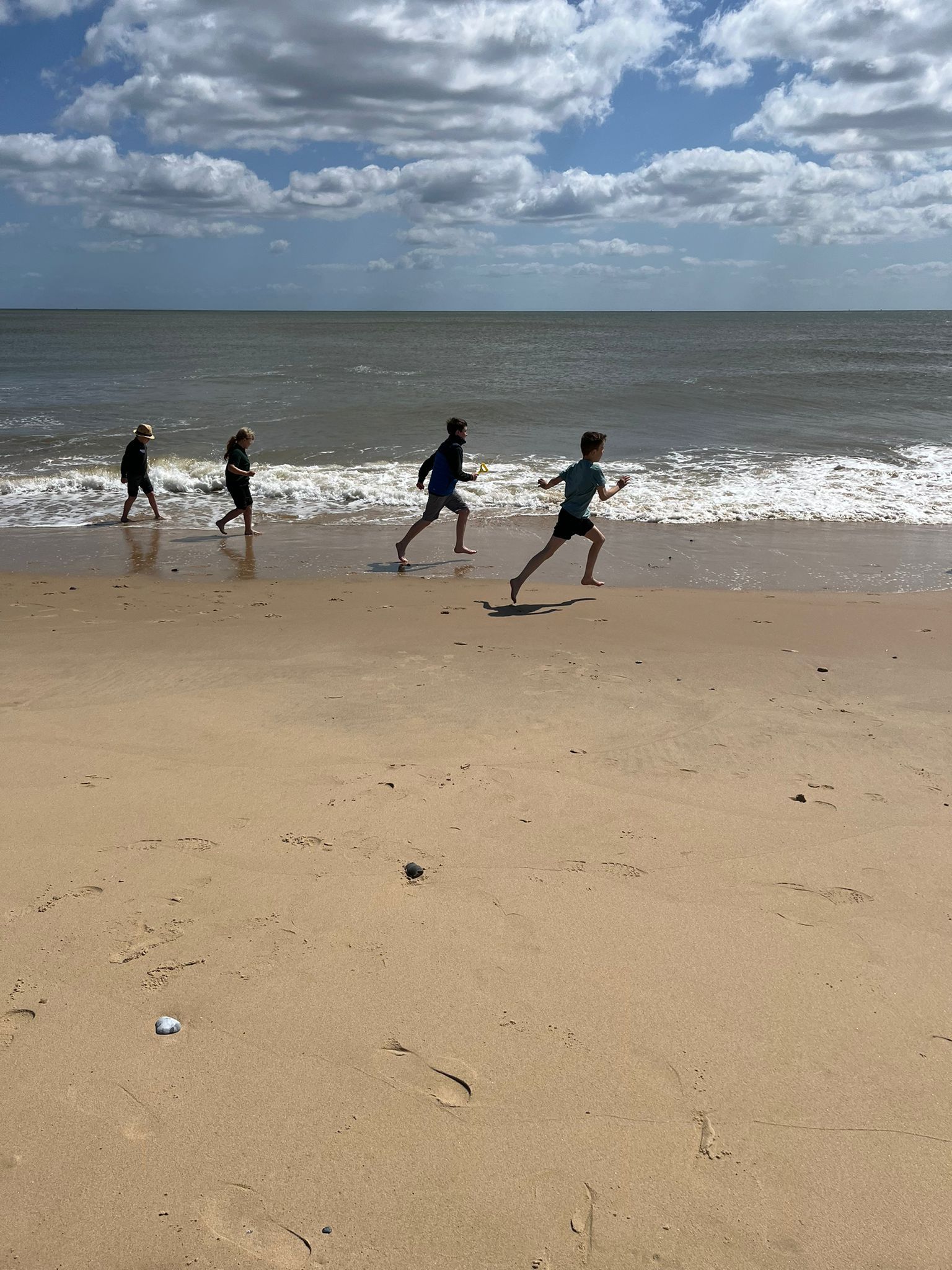 students playing at the beach