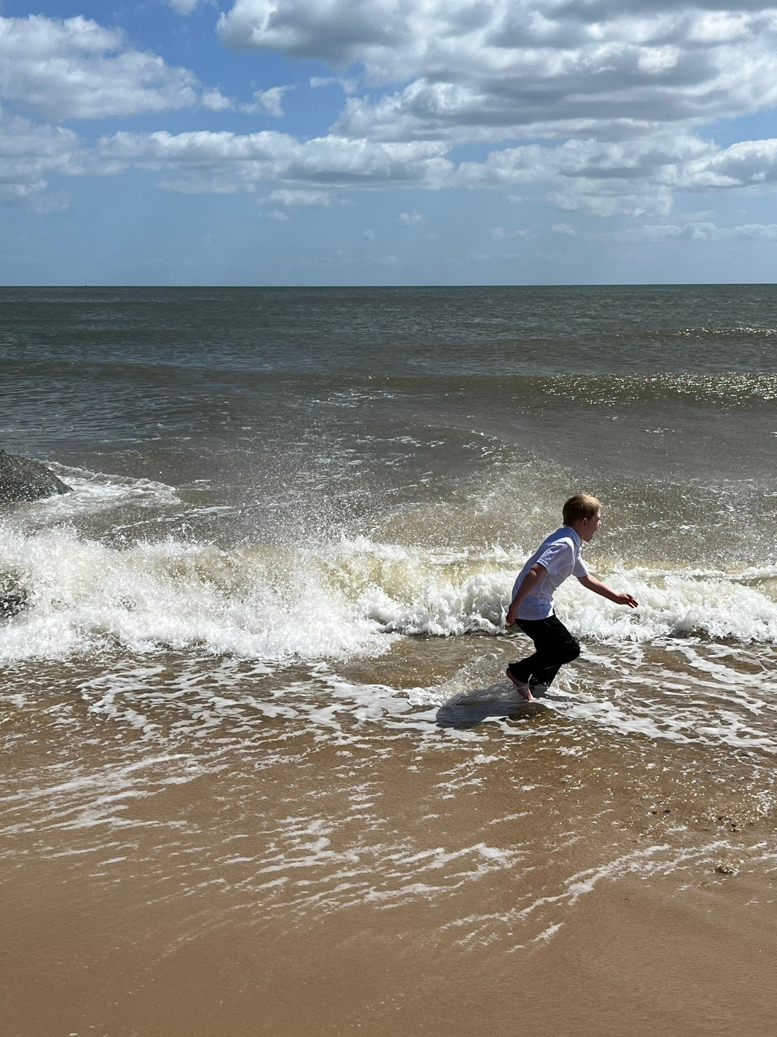 student playing in the water