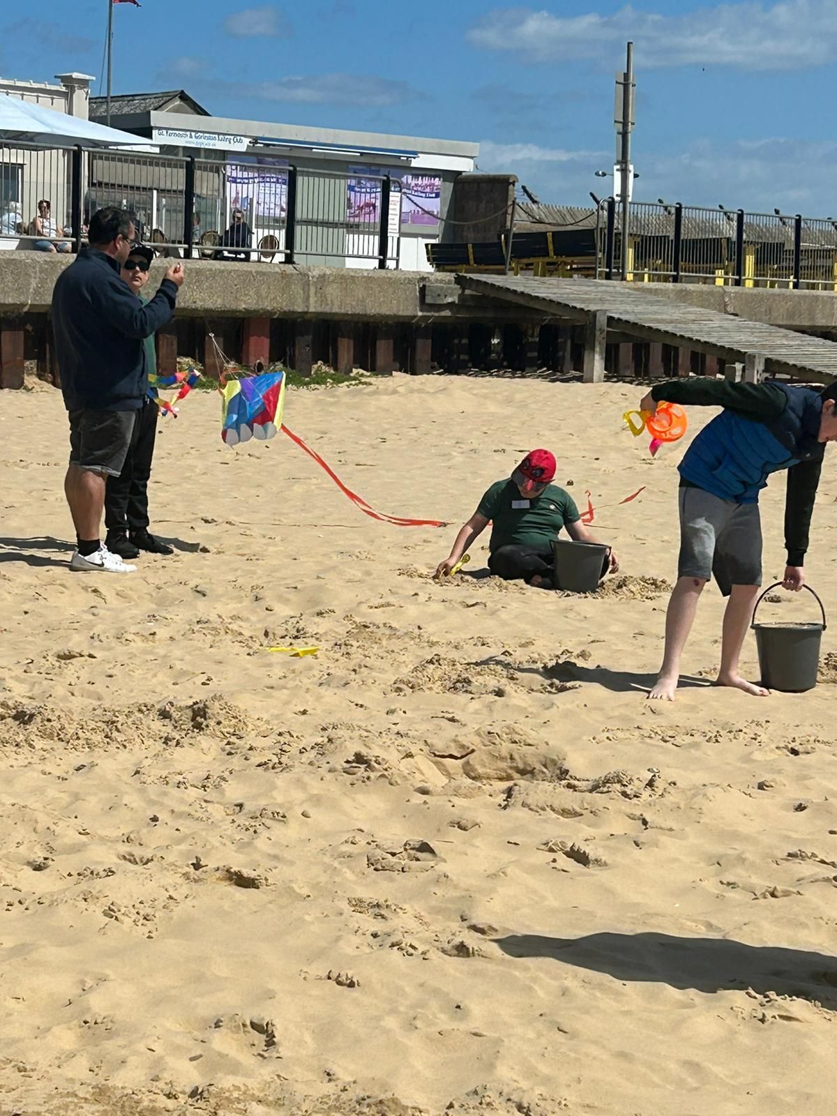 students playing together in the sand