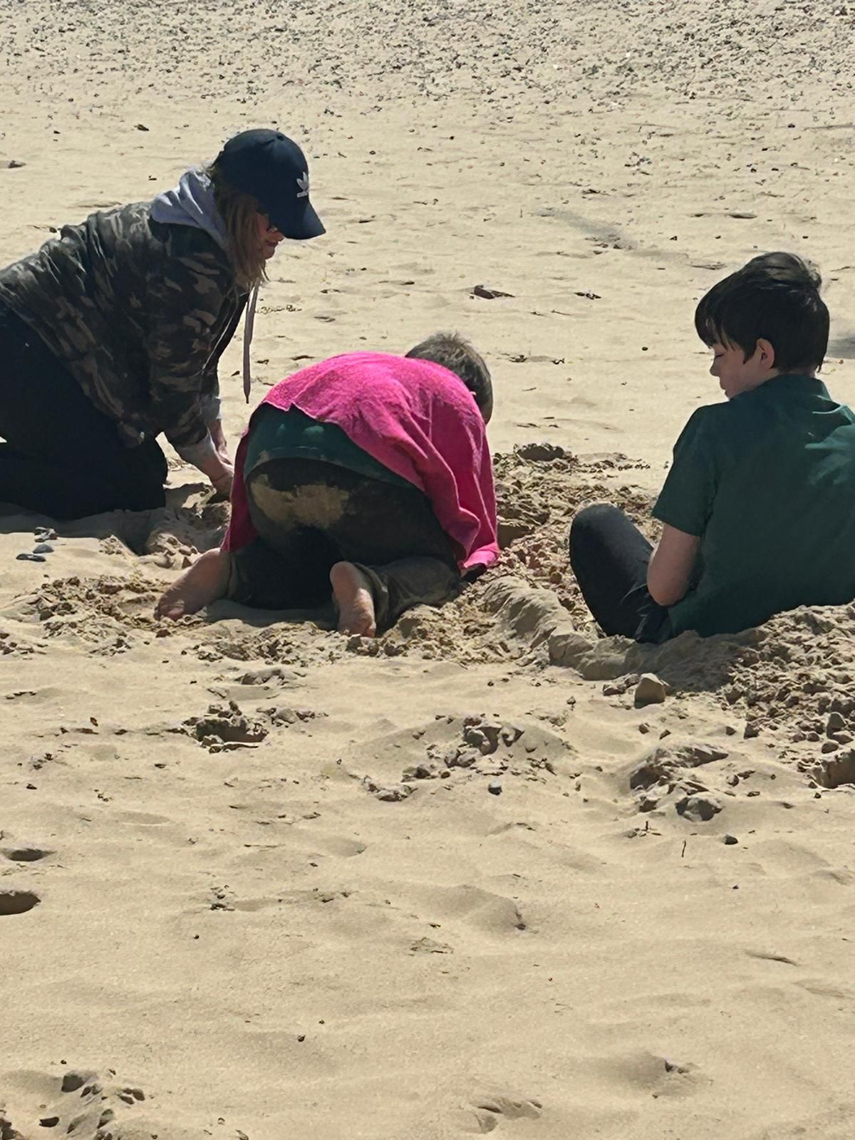 students playing in the sand together