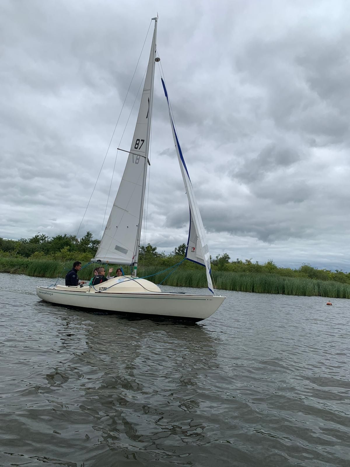 students and staff on a boat