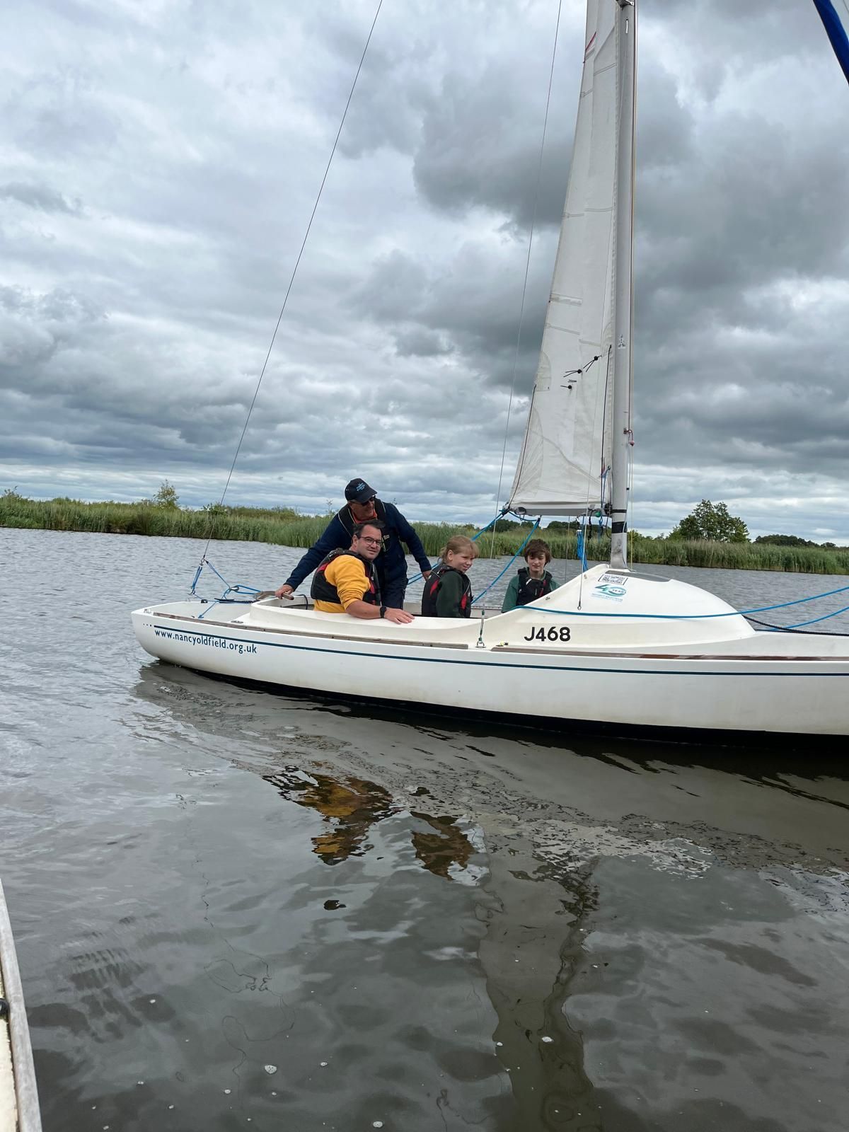 student and staff on a boat