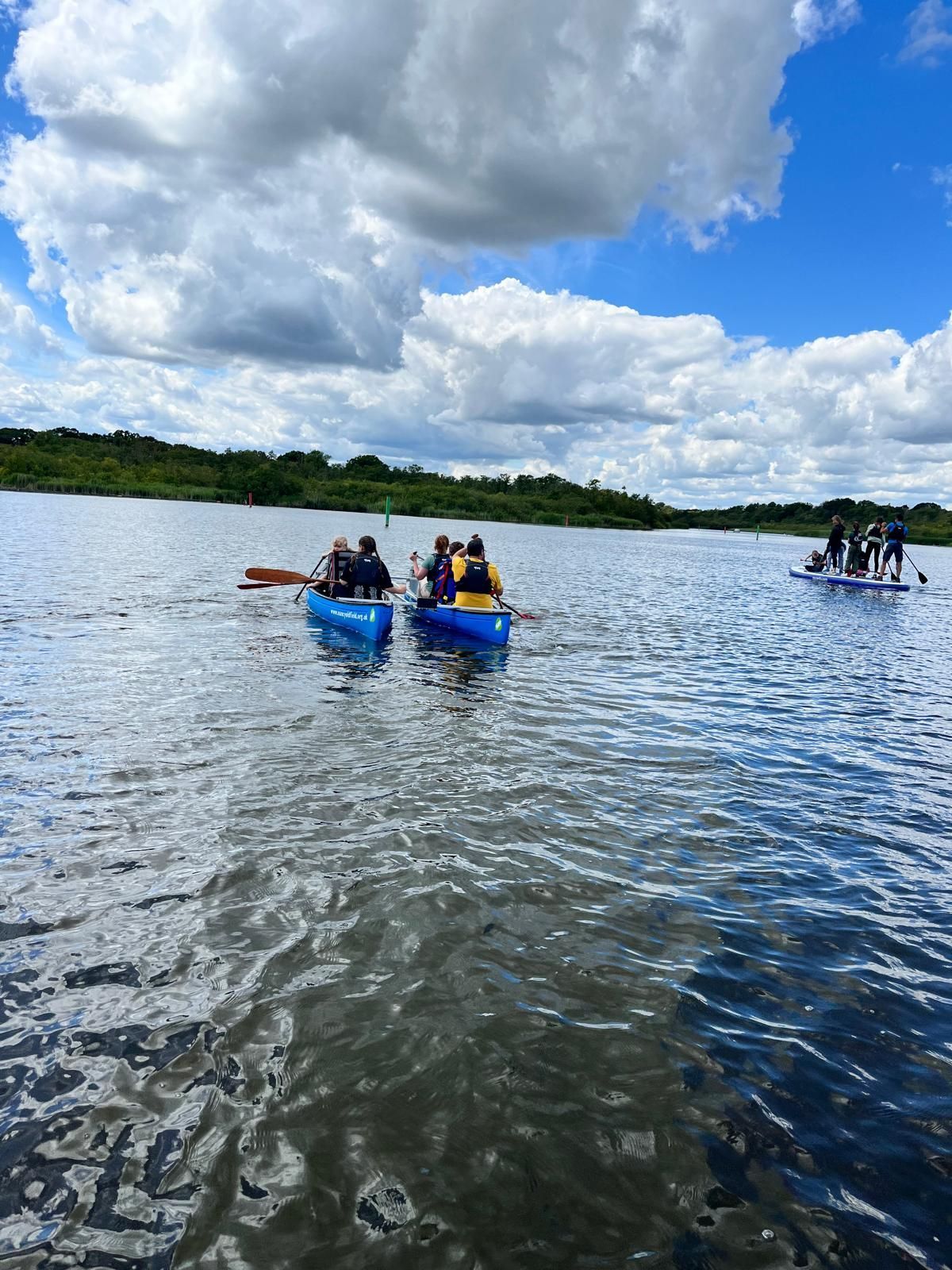 students and staff on a boat